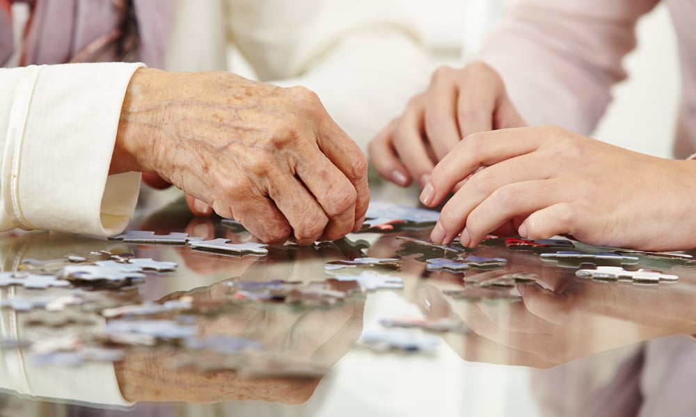 care-worker-and-resident-solving-puzzle